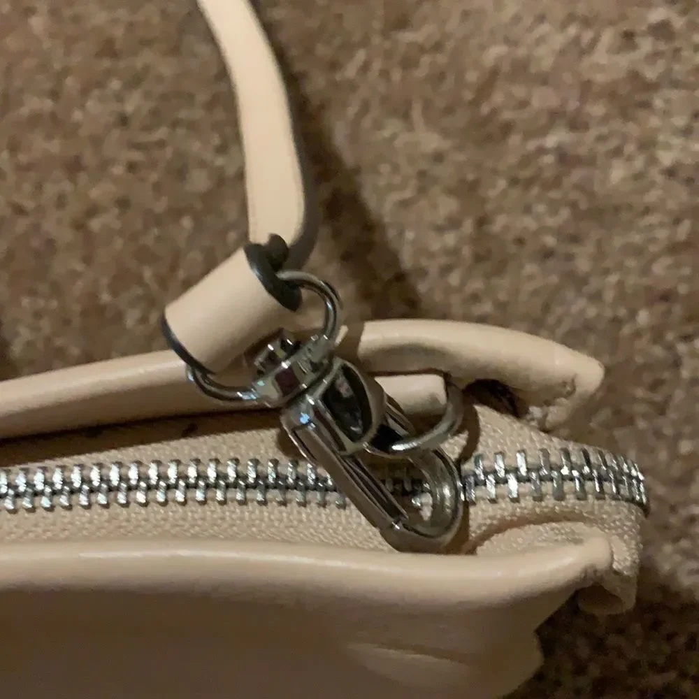 Vince Camuto soft pink crossbody wristlet.